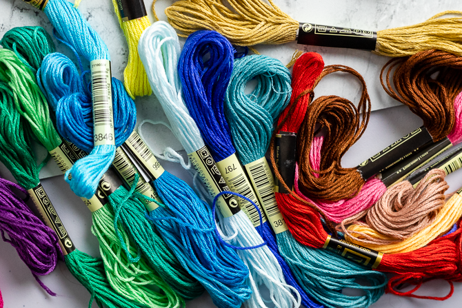 pile of embroidery floss in rainbow colors