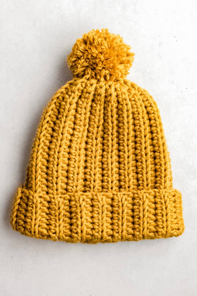 yellow crochet beanie hat with a simple and modern stitch pattern for stretchy ribbing