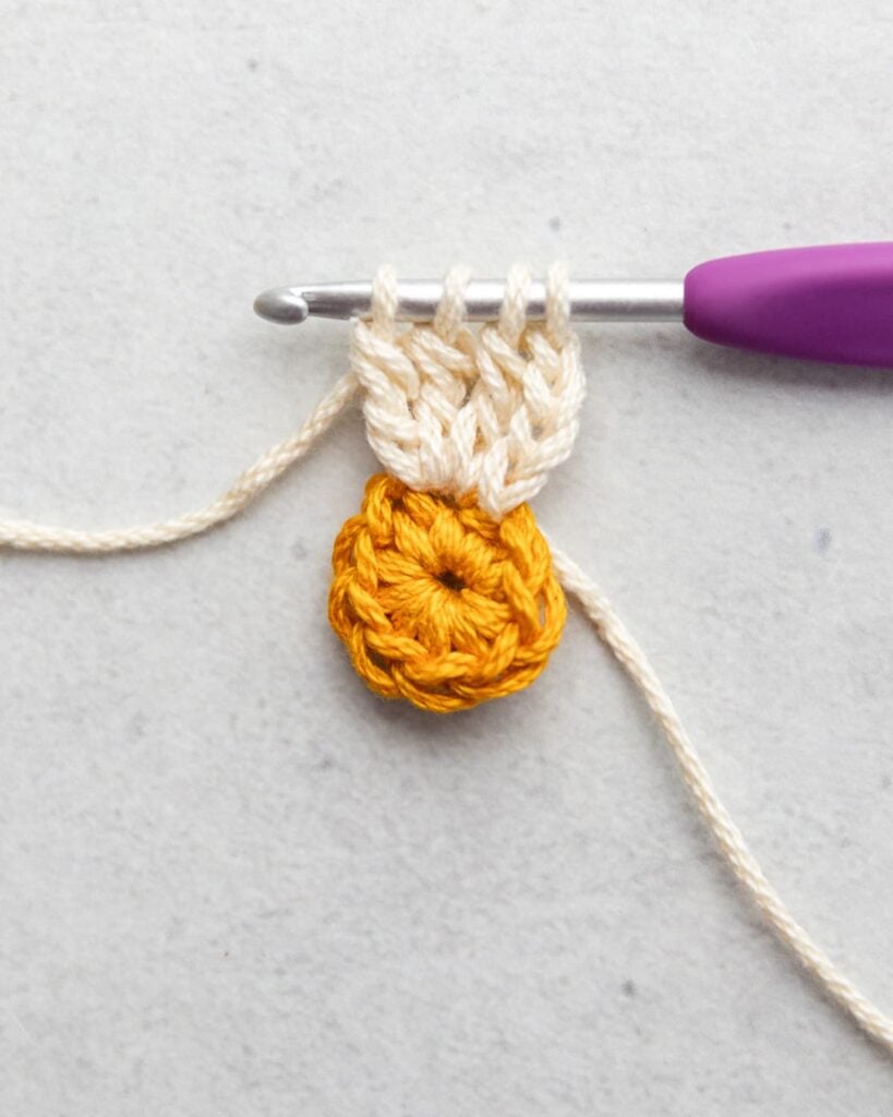 working a treble crochet cluster to make a petal